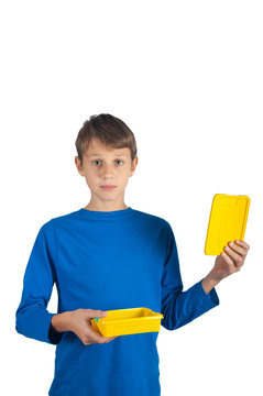 Sad Kid In Blue Shirt Holding Plastic Yellow Empty Lunch Box And Cover