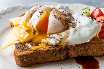 Poached Egg on Toast Bread with Cheddar Cheese, Balsamic Vinegar, Salad and Black Sesame or Cumin Seeds