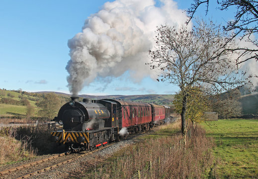 Hunslet Austerity No. 69 'Norman' eases past Priors Lane Permanent Way yard while hauling the 11:15 Bolton Abbey to Embsay service on Sunday 5th November 2017.