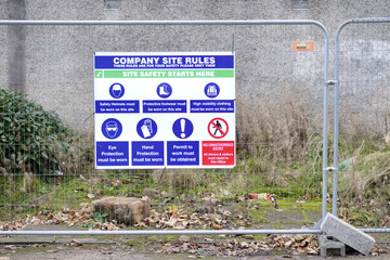 Building site rules health and safety sign on fence