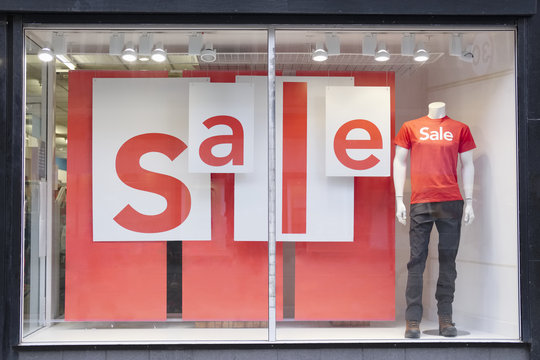 Sale sign in shop mall window and mannequin
