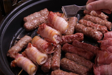 Chicken meat wrapped in bacon and cevapcici