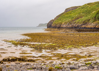 Rocks and coastline at Tenby South Beach, Tenby, Wales, Uk