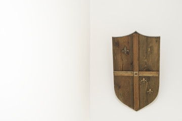 Wood shield on wall against minimal  white background 