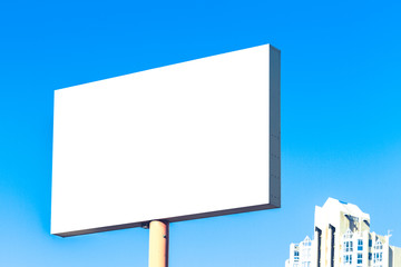 Mock up of blank billboard, outdoors advertising board with city and blue sky background