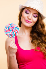 Woman holds colorful lollipop candy in hand