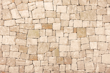 Masonry wall of stones with irregular pattern texture background