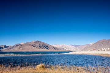 Fototapeta na wymiar Landscape image of Pangong lake with mountains view and blue sky background