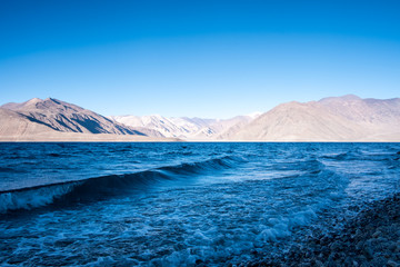 Landscape image of Pangong lake with mountains view and blue sky background