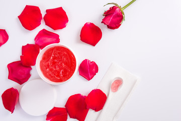 Spa accessories in Red. Body cream with rose petals.
