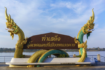 Naklejka premium Naga statue , one of Landmarks at Sadet pier along Mekong river ( foreign texts saying Tha Sadet , Nong Khai ) Thailand