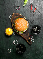 Fast food. Burger with cola and sauce.