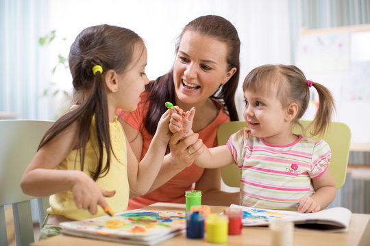 Children and mother with finger paints