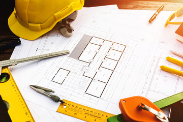 A desk of contractor engineers who are going to build a low cost home and save energy