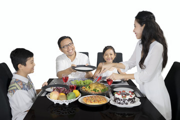 Young woman giving meals to her family