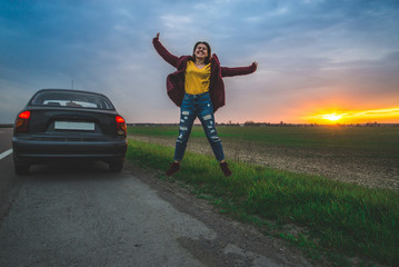 Fototapeta premium woman rests on sideroad at sunrise
