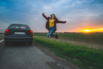 Fototapeta premium woman rests on sideroad at sunrise
