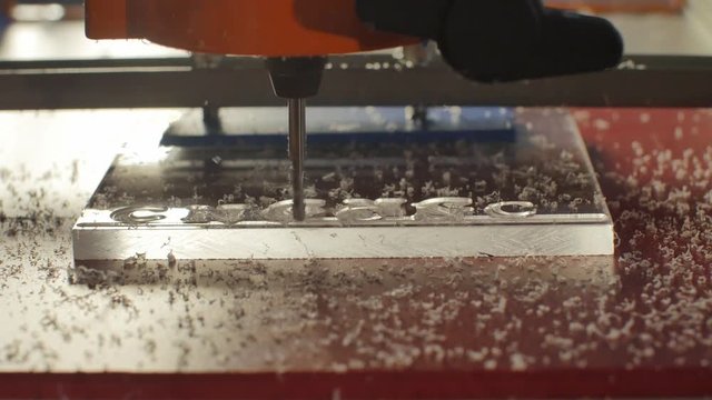 CNC milling machine processes a plastic blank