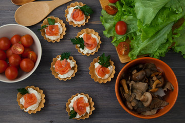 lettuce leaves , appetizer and cherry tomatoes on a dark wooden background