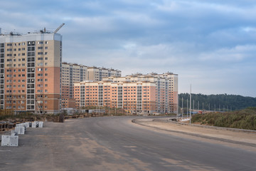 Obraz premium New constructed buildings in the city and a asphalt road to the district