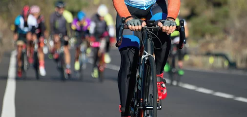 Crédence de cuisine en verre imprimé Vélo Cycling competition,cyclist athletes riding a race,climbing up a hill on a bicycle,cyclist in an escape