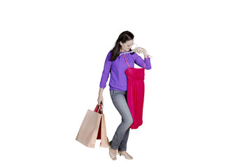 Beautiful woman trying new dress on studio