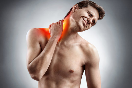 Man feeling exhausted and suffering from neck pain. Medical concept.