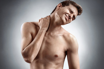 Fototapeta premium Man suffering from neck pain. Medical concept.