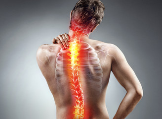 Young man holding his neck in pain. Medical concept.