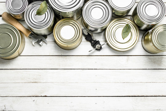 Tin cans with food and opener.