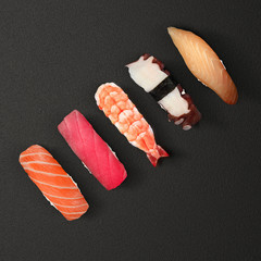 Japanese cuisine. Sushi set over dark background.