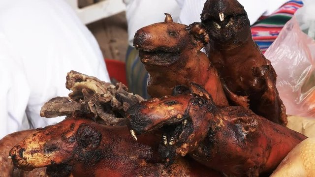 close up shot of cuy, fresh cooked guinea pig, at a market in cuzco, peru