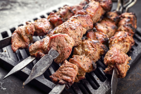 Traditional Russian shashlik on a barbecue skewer as top view on grillage