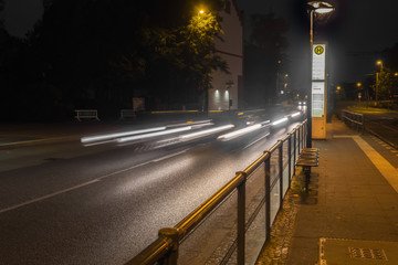 Road at night with light trails of cars