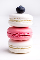 Pile of Pastel Color and Tasty Macarons on White Background White and Pink Macaron Vertical Close Up