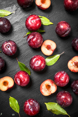 Fresh plums with leaves.