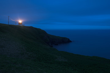 Kiritappu cape lighthouse on the rocky cliffs after sunset, Hokkaido, Japan