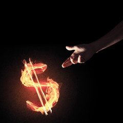 Concept of money making with dollar currency fire symbol on dark