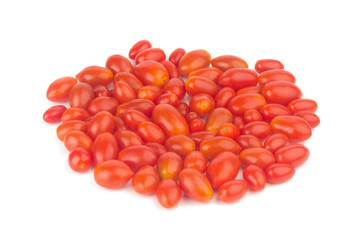 baby plum tomatoes. cherry tomatoes. closeup. color red. pile. isolated on white background