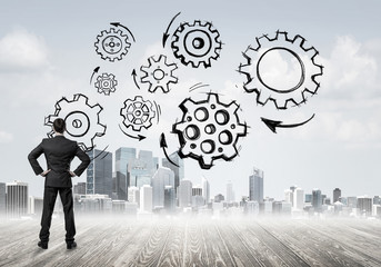 Cogwheel engine drawn on screen as symbol for teamwork and coope