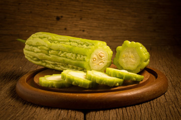 gourd. bitter. on old wooden. cut. slice