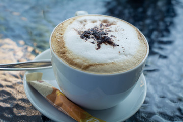 hot coffee with foam milk art, latte art coffee ( Filtered image processed vintage effect.)