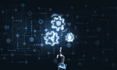Glowing cogwheel mechanism icon on dark background as symbol of teamwork