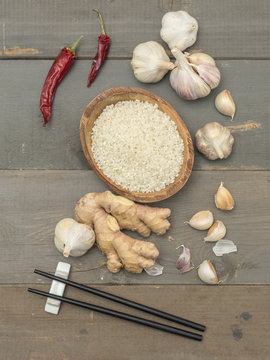 rice and garlic on a wooden table. 