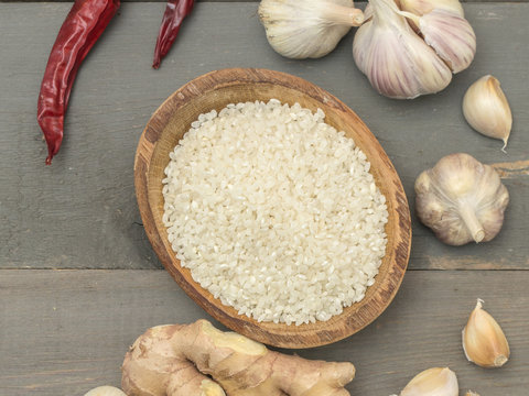 rice and garlic on a wooden table. 