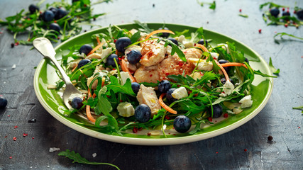 Fresh Chicken salad with Blueberries, feta, carrots, nuts and green vegetables. healthy food concept