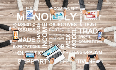 Top view of businesspeople sitting at table and using gadgets