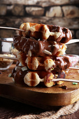 Belgium waffles with chocolate sauce. popsicles with chocolate and wafer.