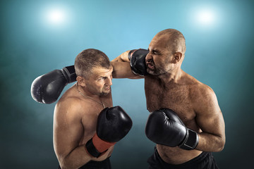Fototapeta na wymiar Two professional boxers, athletes in dynamic boxing action on th