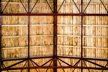 Wooden roof, visible red rafters and light brown laths